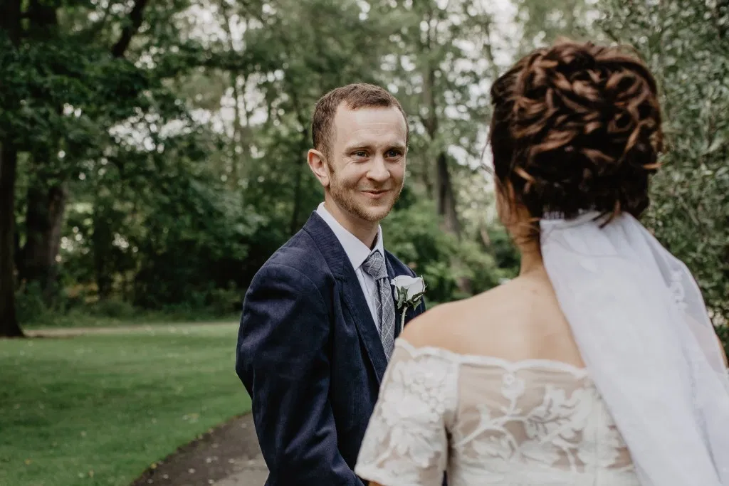 Groom seeing bride at first look before their wedding
