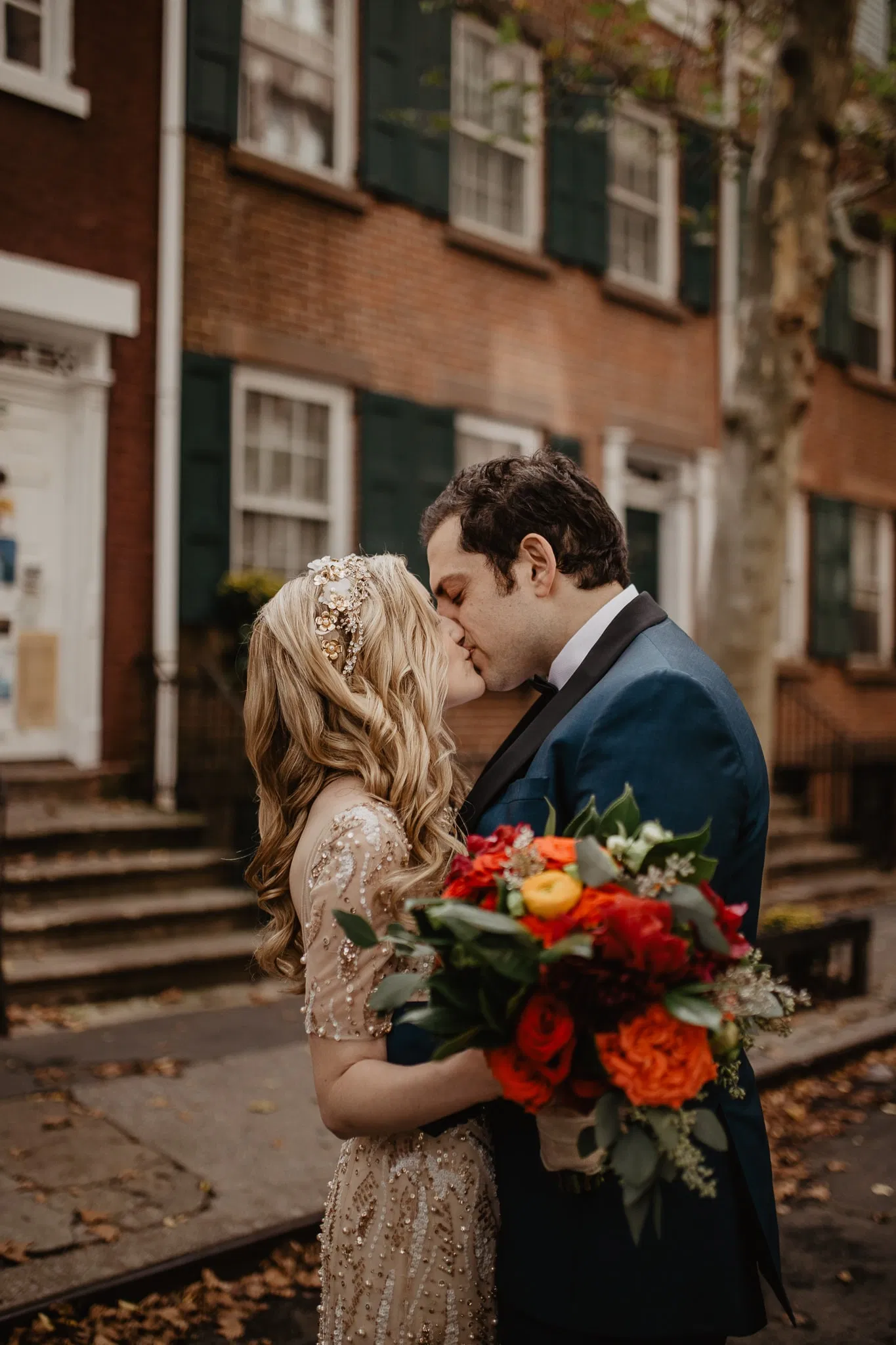 Bride and groom kissing in front of brownstone in New York City during first look with Jessy Herman Photo