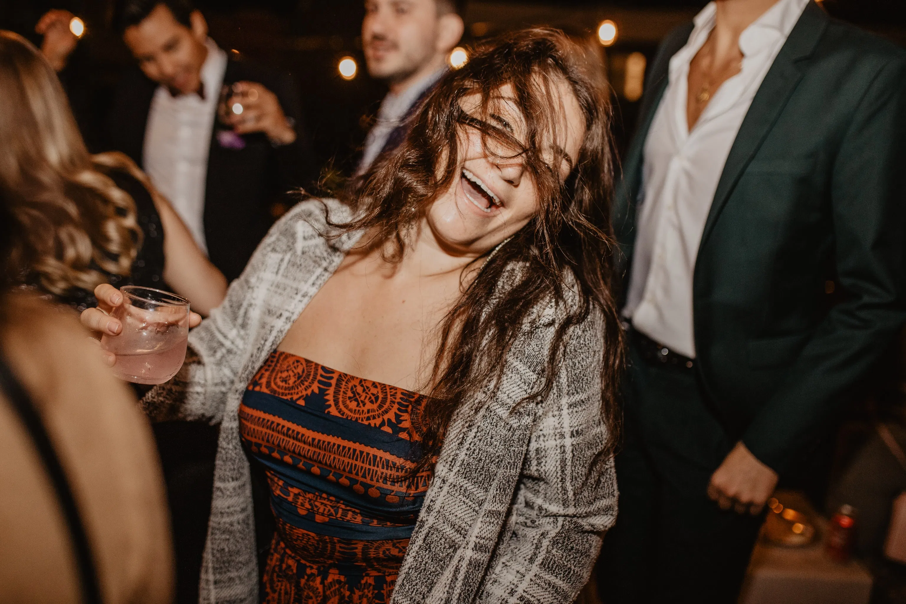Woman laughing and dancing at a new york city wedding reception