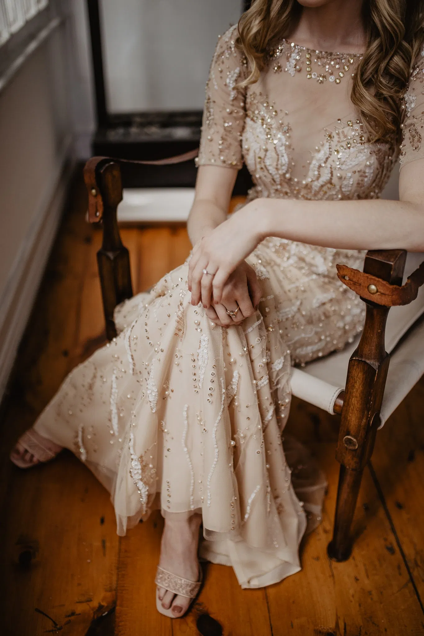 Detail shot of bride's hands and dress on wedding day by Jessy Herman Photo