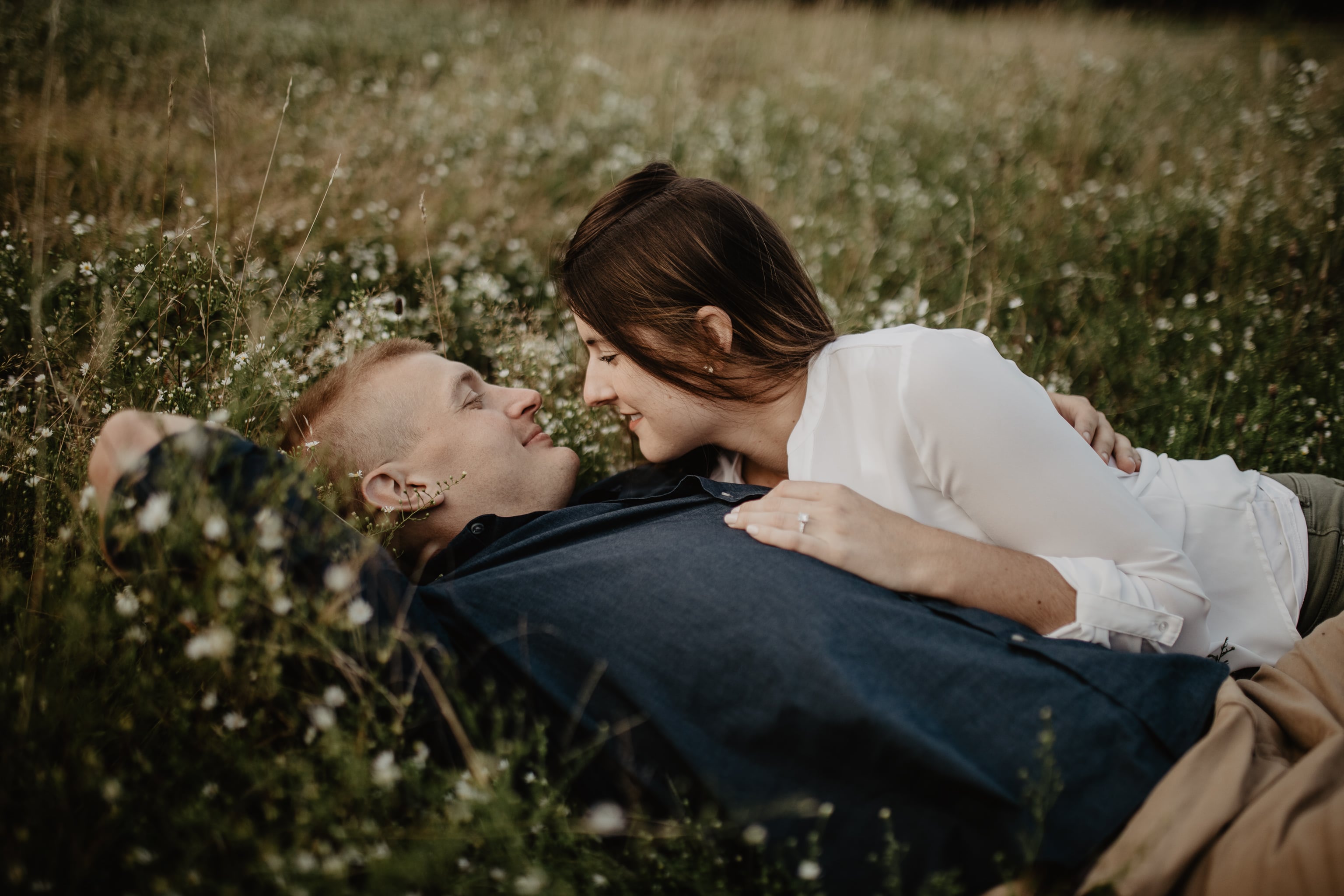 Couple laying in field during engagement session at Knox Farm State Park