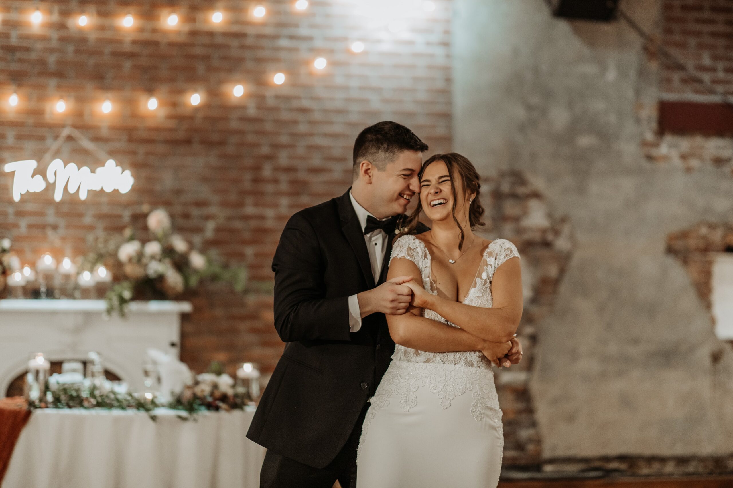 Husband and wife embrace as they have their first dance