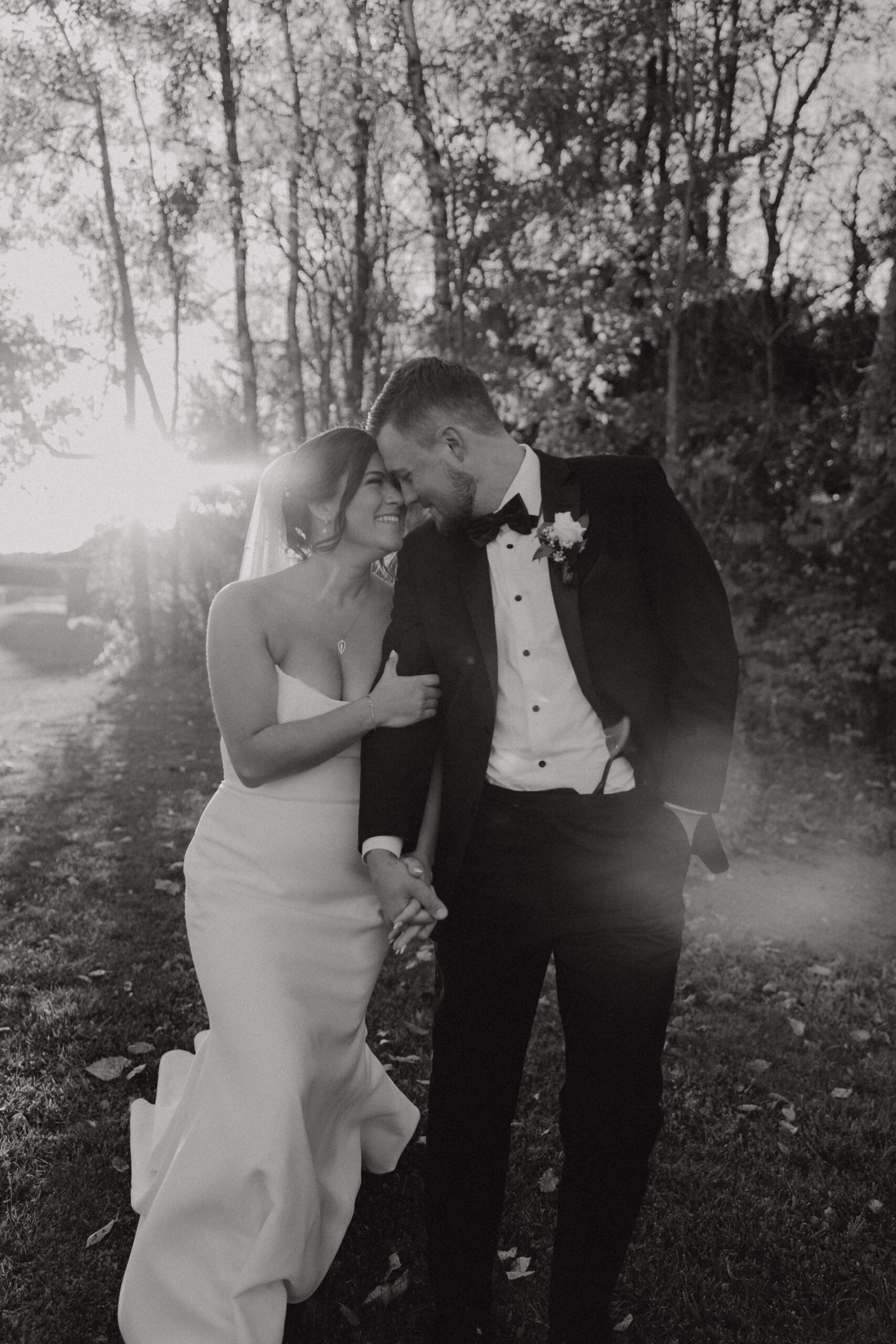 Black and white photo of bride and groom on their wedding day walking the Annex WNY photographed by Buffalo Wedding Photographer Jessy Herman Photo