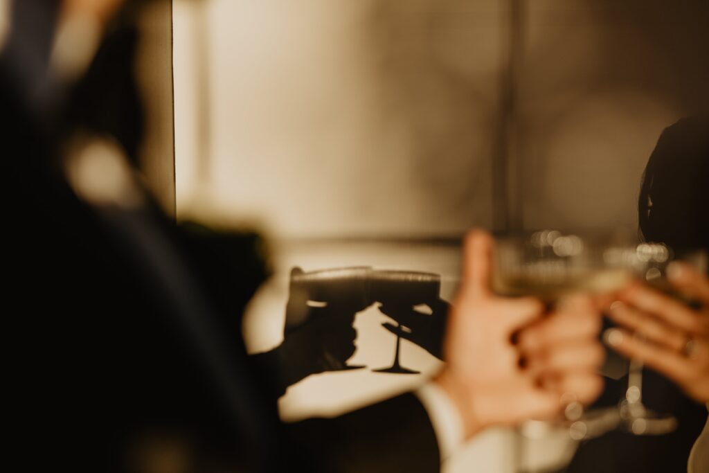 Shadow of couple doing a cheers with their champagne glasses 