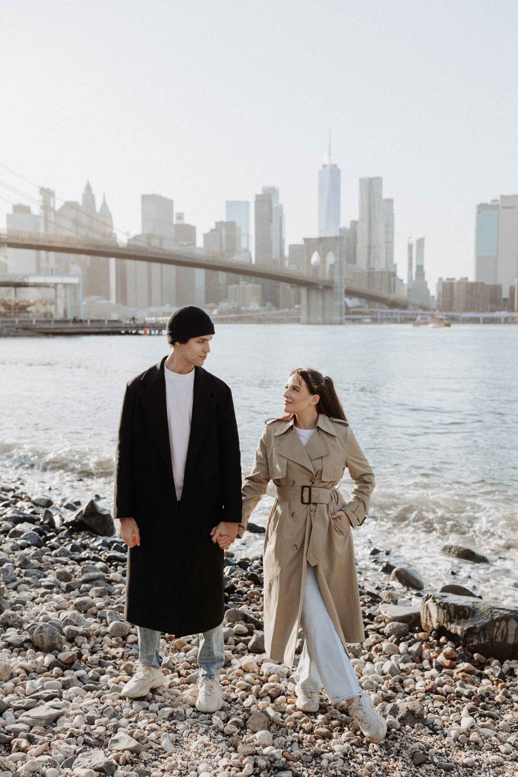 Trendy couple holding hands in front of New York City skyline photographed by Jessy Herman Photo