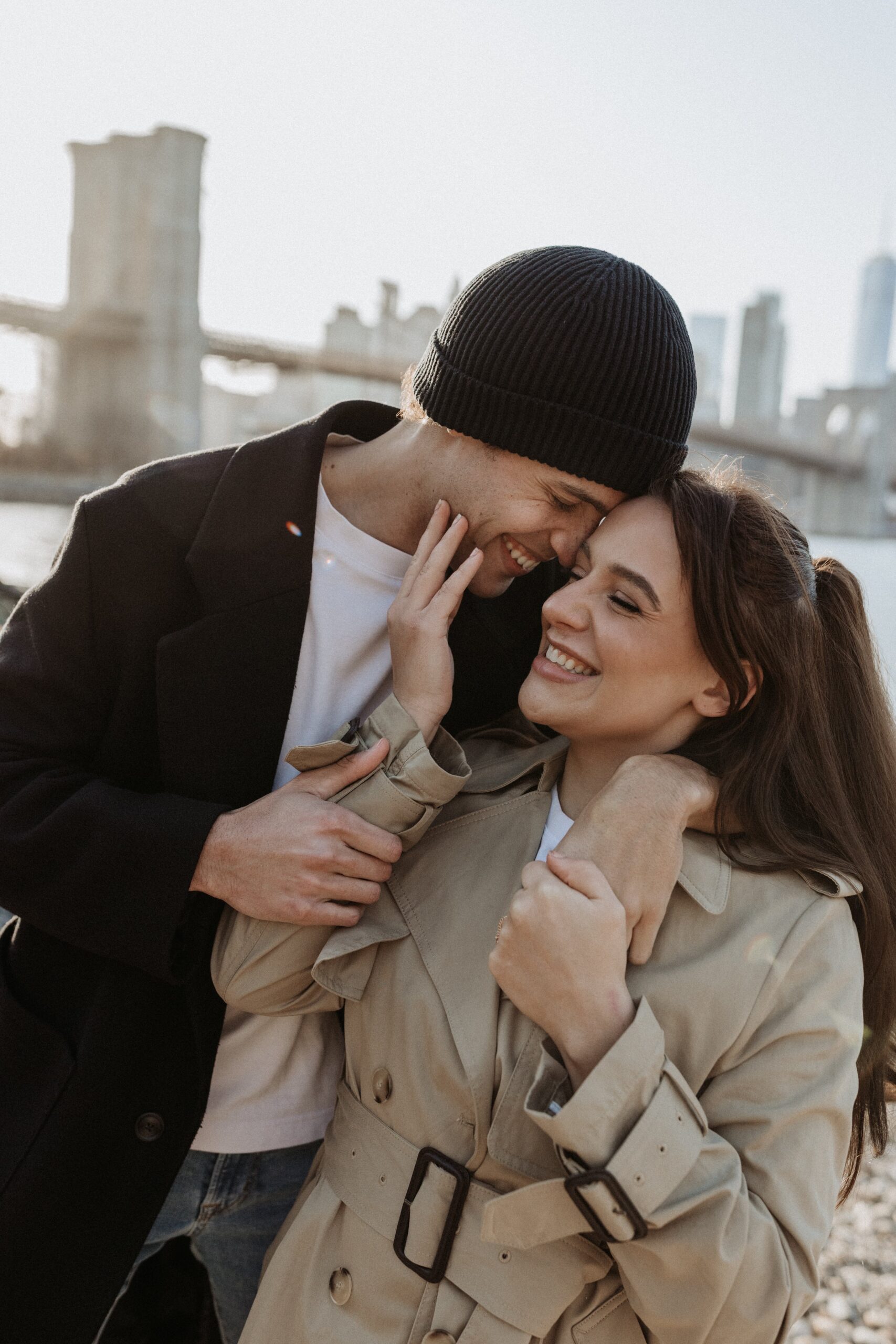 Cute NYC couple smiling and embracing photographed by Jessy Herman Photo
